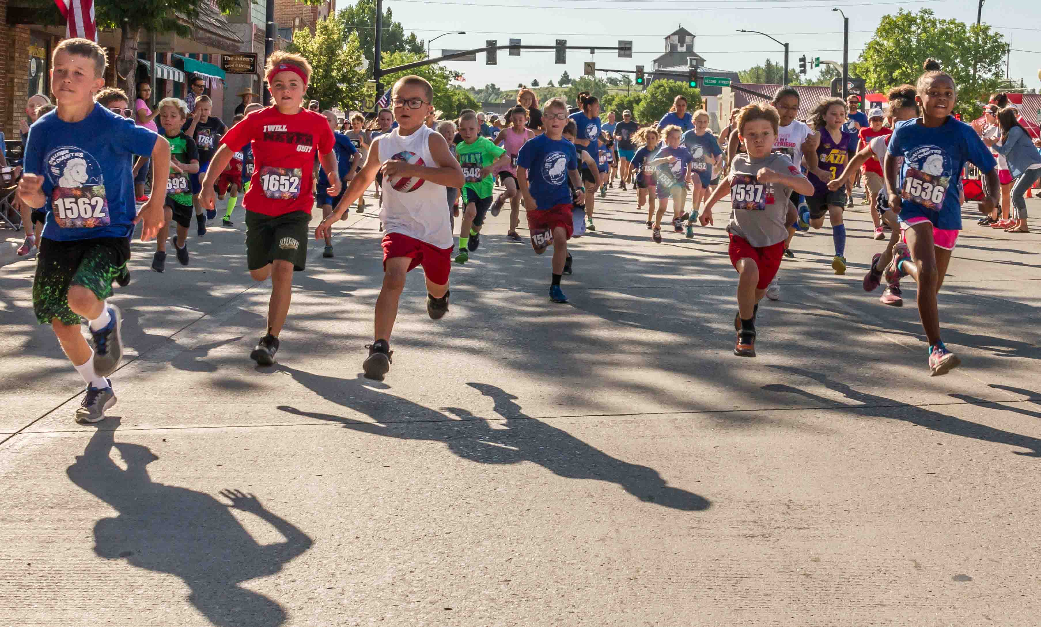 Youth in the half-mile Mad Dash run down Main Street.